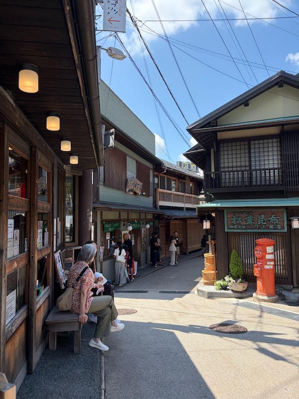 Historic narrow pedestrian shopping street with traditional wooden shops in Arima Onsen Historic narrow pedestrian shopping street with traditional wooden shops in Arima Onsen